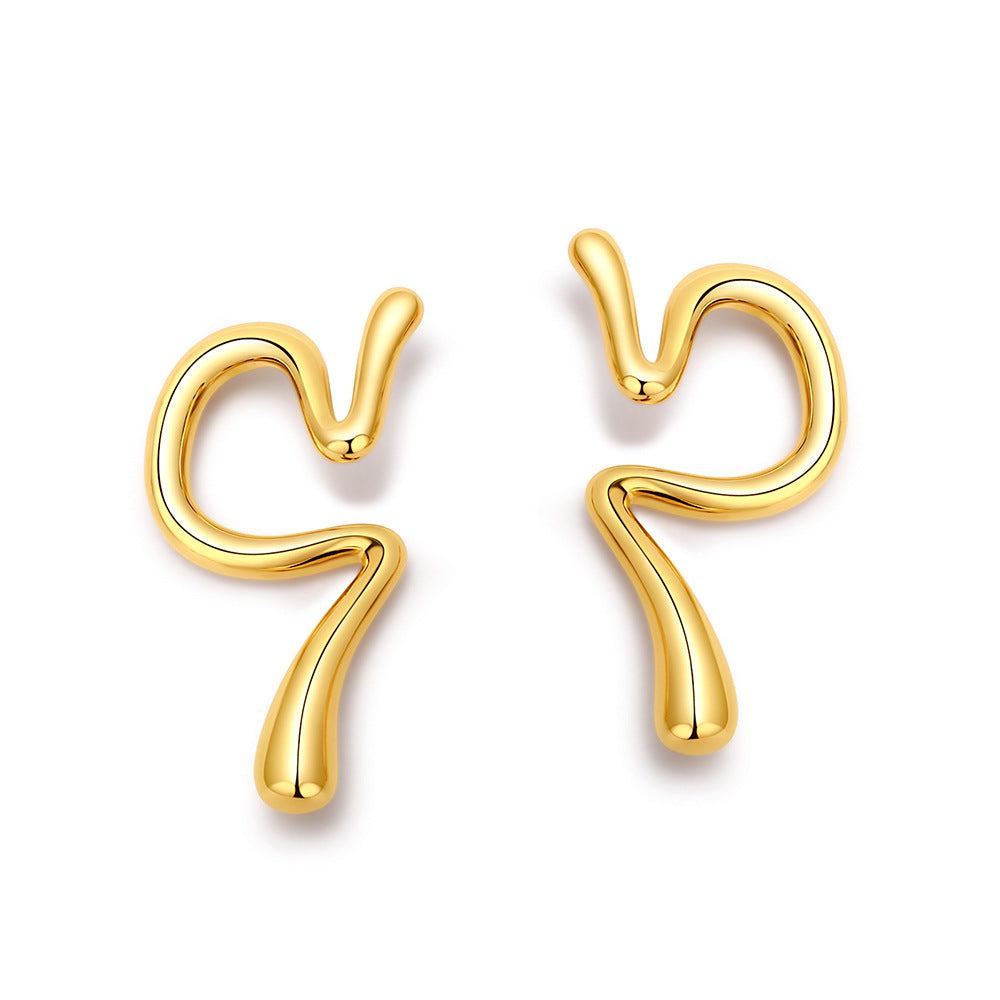 Curved gold tone ear cuffs on a white background