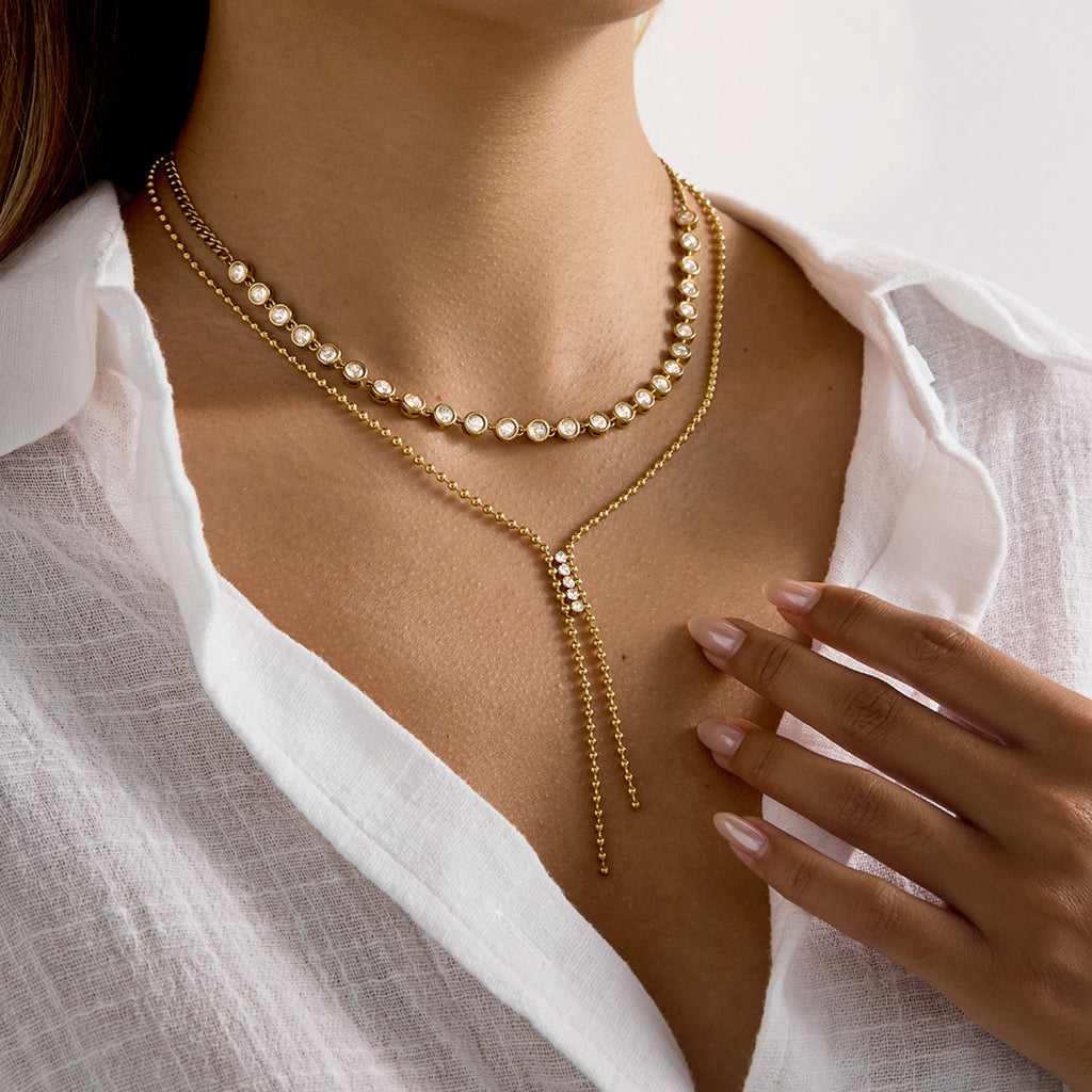 Twin chain tails of the gold plated Y necklace on a model