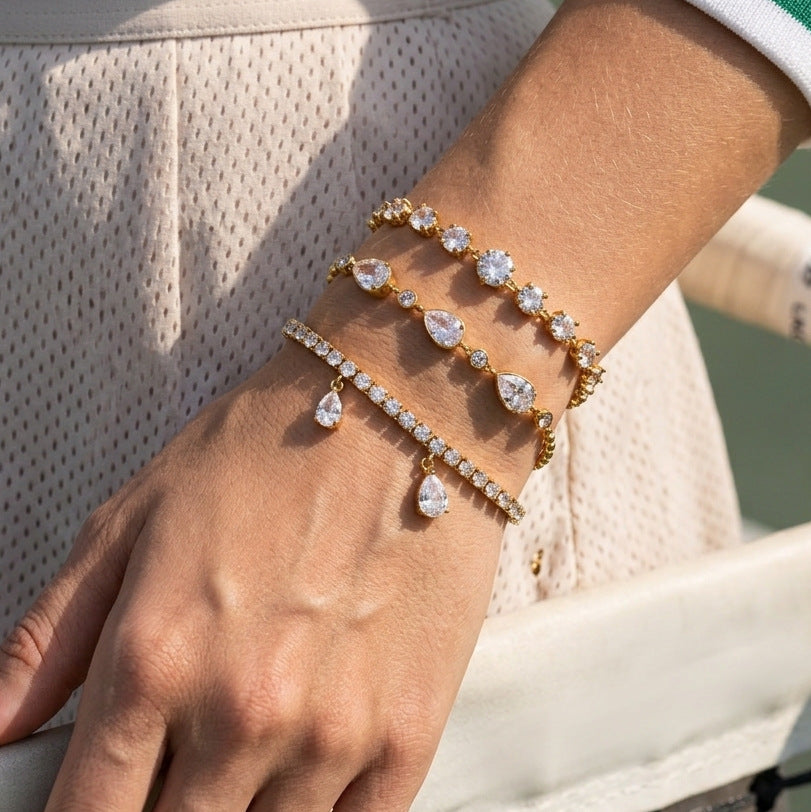 Three clear stone bracelets layered on wrist