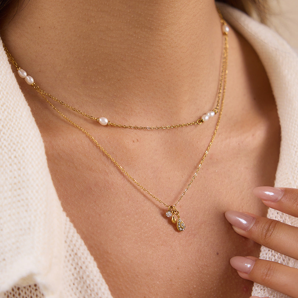 White-accent fine chain necklace layered with another pendant