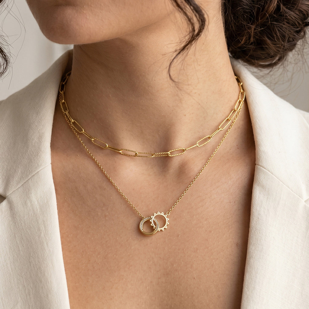 Double-ring necklace layered with a separate elongated-link chain