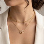 Double-ring necklace layered with a separate elongated-link chain