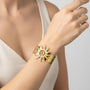 gold plated spiral sun wide cuff bracelet worn on the wrist