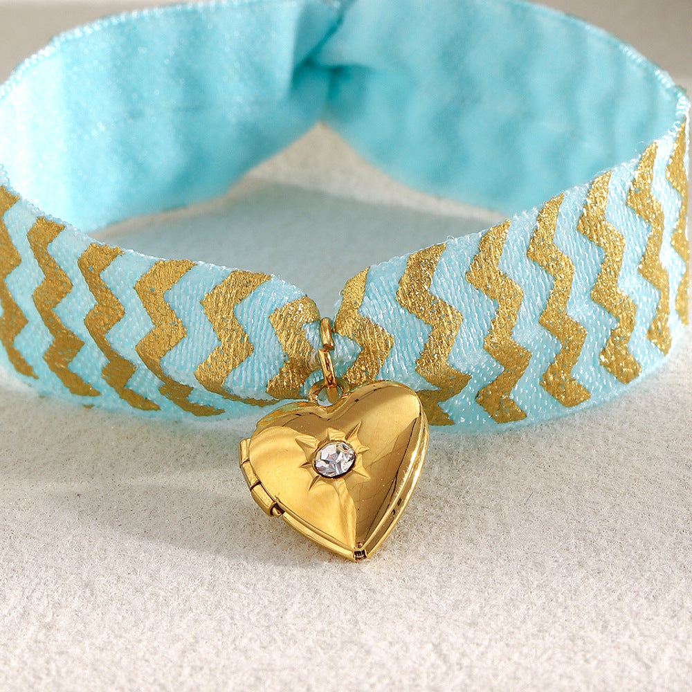 Blue Fabric Tie Bracelet with Gold Plated Stainless Steel Heart Locket — worn view