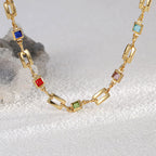 close view of multicolor square accents between open gold links