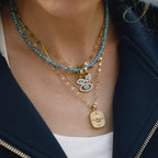 Gold-Tone Evil Eye Stainless Steel Necklace and Earring Collection shown on model