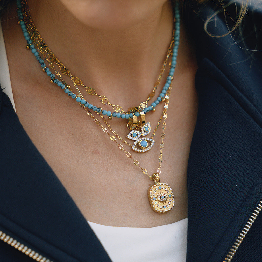 Gold-Tone Evil Eye Stainless Steel Necklace and Earring Collection shown on model