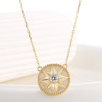 angled close view of eight-point compass star necklace