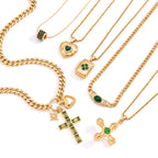 Six gold-tone stainless steel necklace designs with green accents