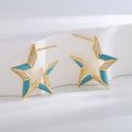 gold plated blue resin star zirconia stud earrings upright in studio