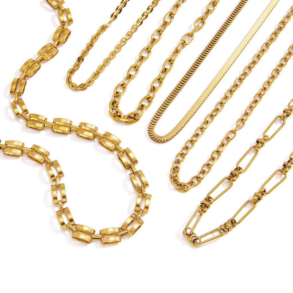 Gold tone necklace assortment on a white background