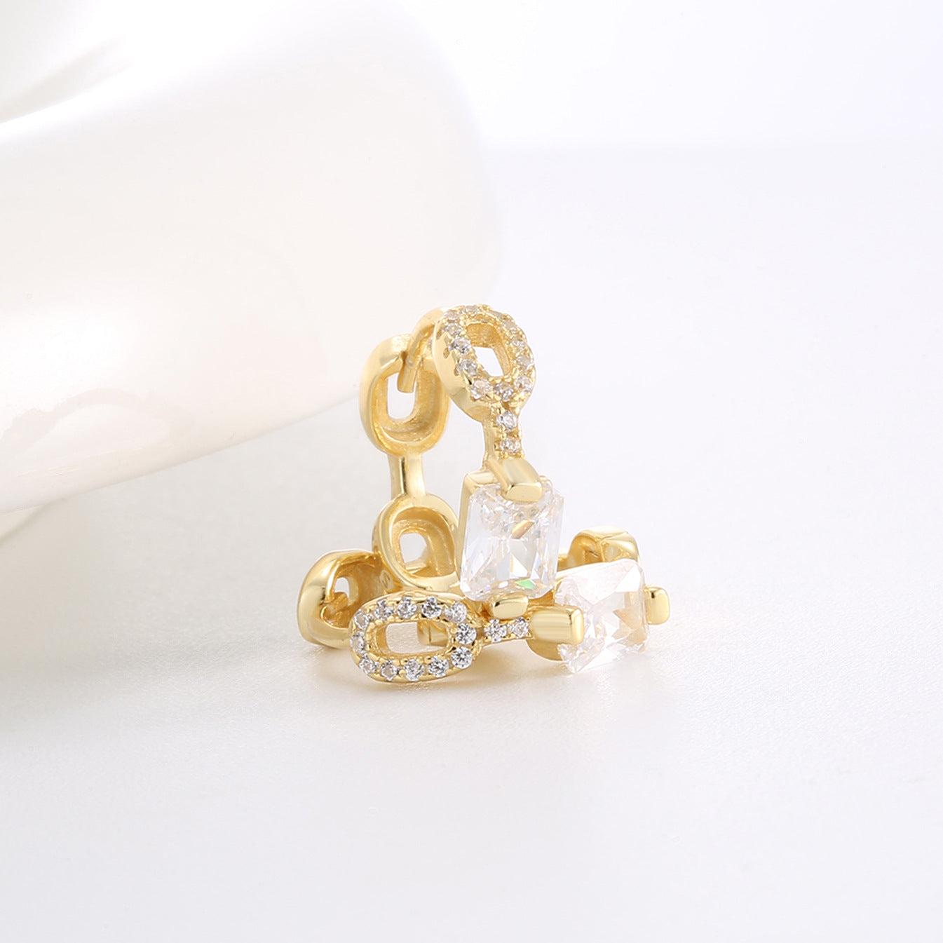 stacked view of segmented zirconia and oval-link huggie earrings