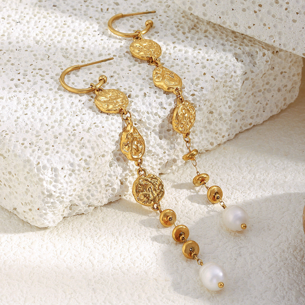 gold plated hammered medallion and pearl drop earrings on stone
