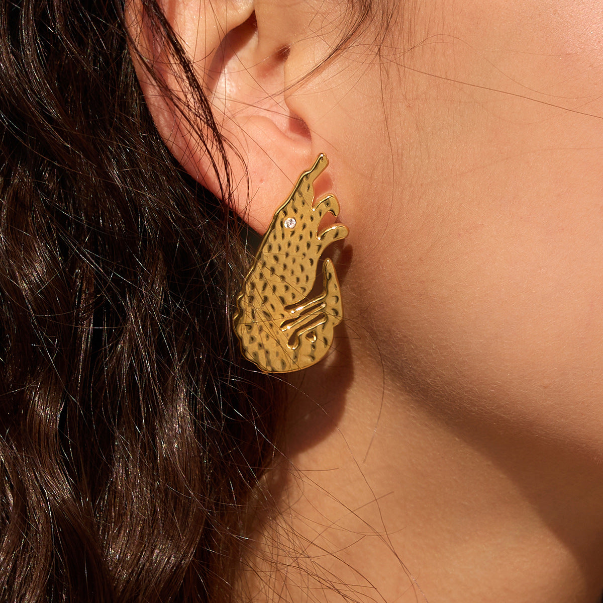 Close-up of sculpted shrimp earrings