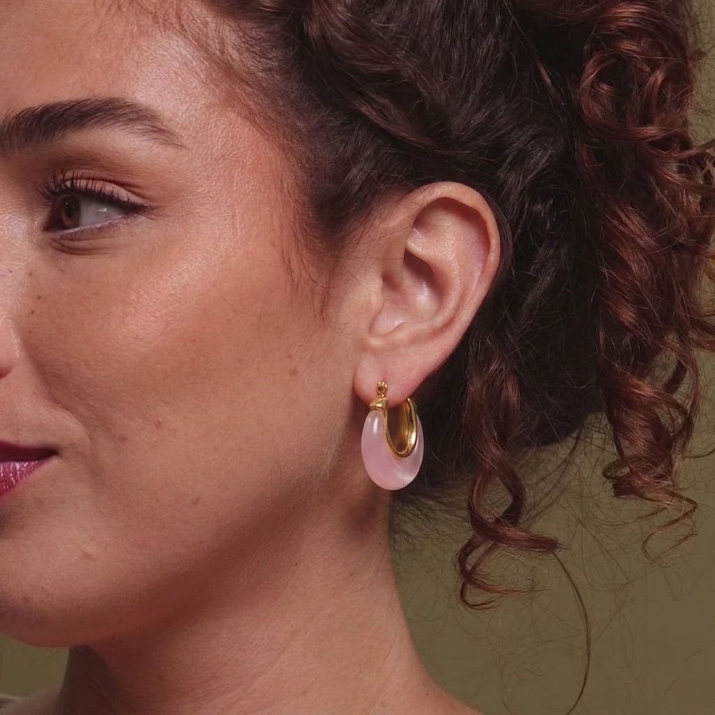 Pink resin hoop shown on ear