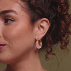 Pink resin hoop shown on ear