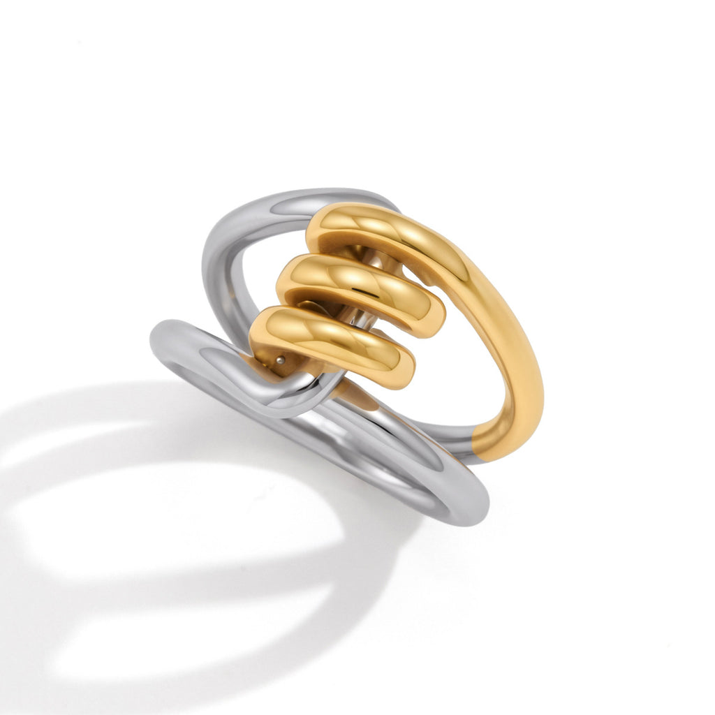 Angled view of gold-tone loops between silver-tone bands
