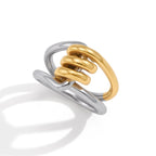 Angled view of gold-tone loops between silver-tone bands