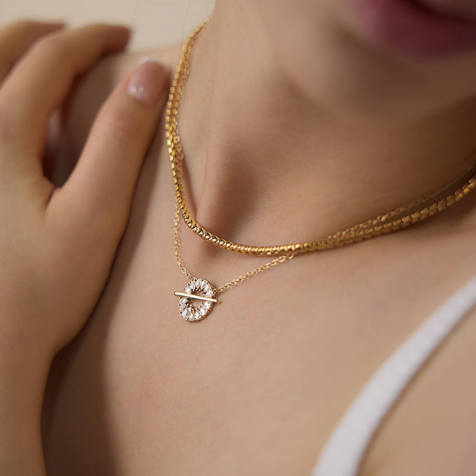 Close-up of circular halo pendant and horizontal bar when worn