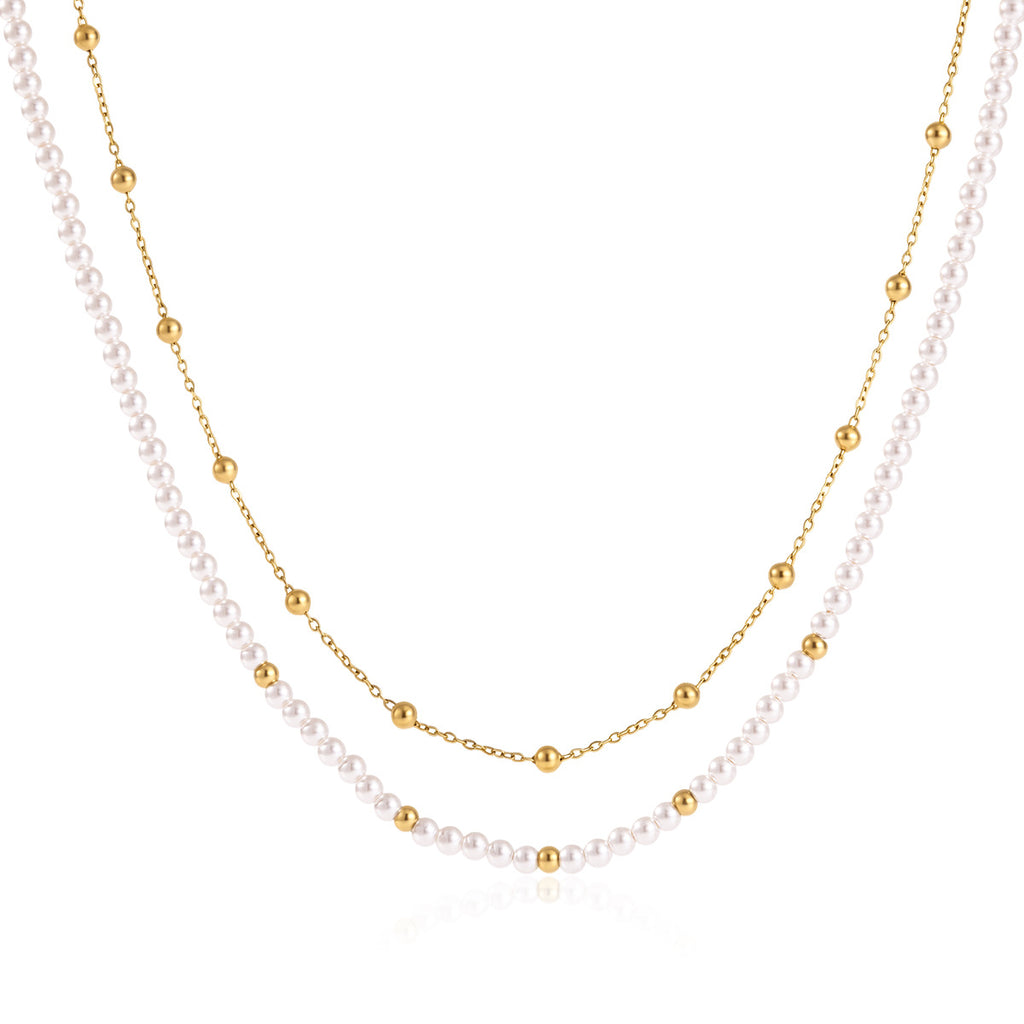 Layered acrylic pearl necklace on white