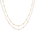 Layered acrylic pearl necklace on white
