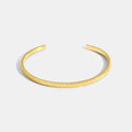 gold plated ribbed open cuff bracelet on white
