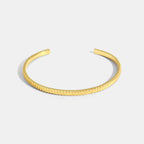 gold plated ribbed open cuff bracelet on white