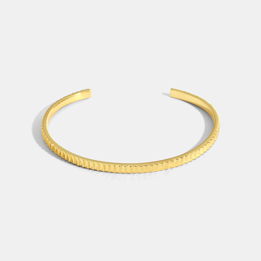 gold plated ribbed open cuff bracelet on white