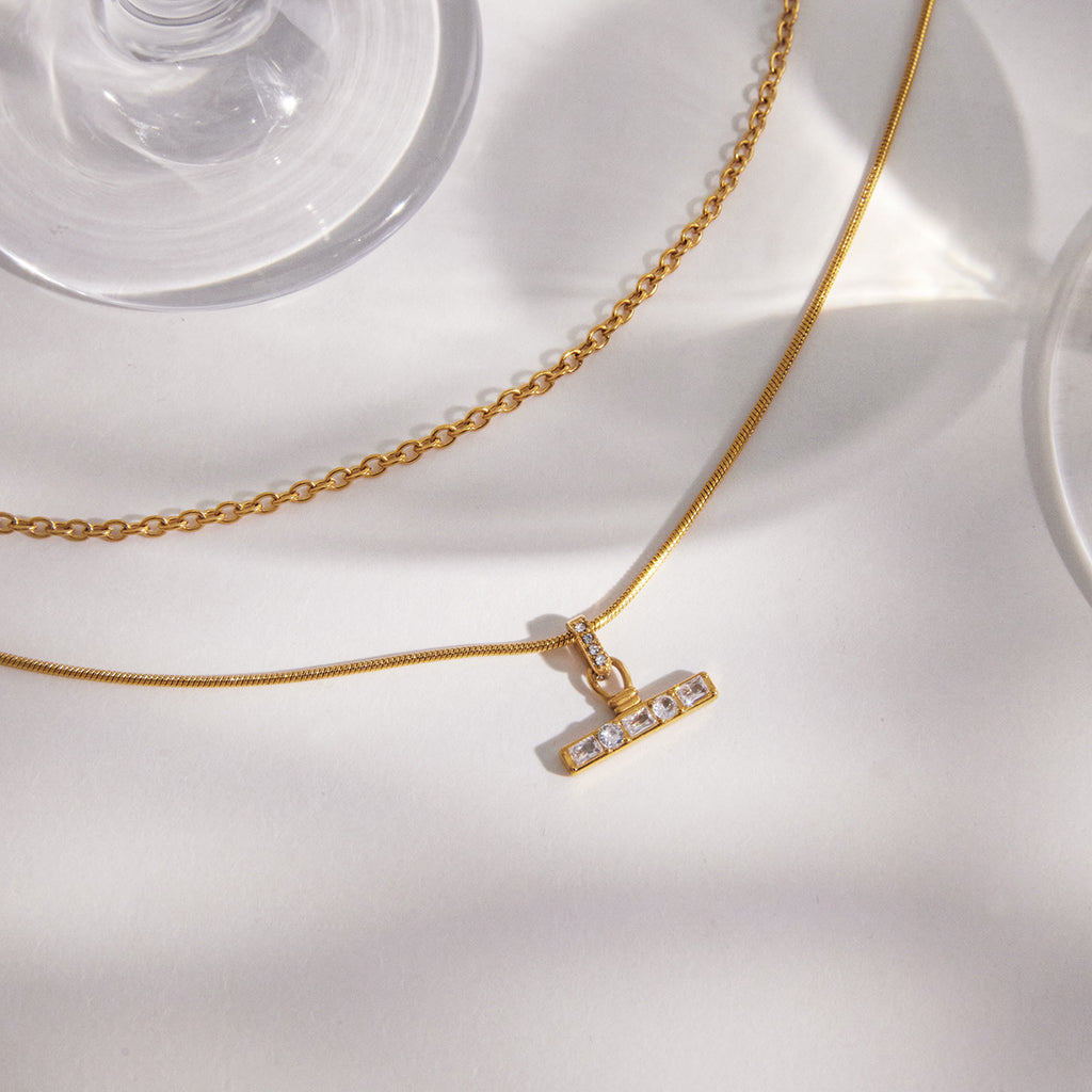 T-bar pendant and contrasting chain textures close-up