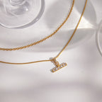 T-bar pendant and contrasting chain textures close-up
