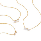 Gold plated necklace options arranged on white background