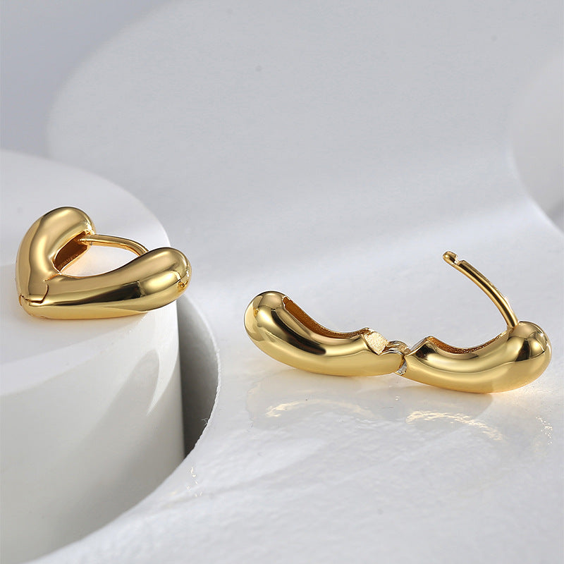 open view of gold plated brass heart huggie earrings