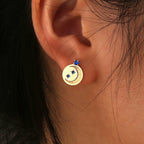 blue star and moon celestial disc stud earring worn on the ear