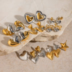 Two-tone heart earrings with bow and stacked-heart options in a group display