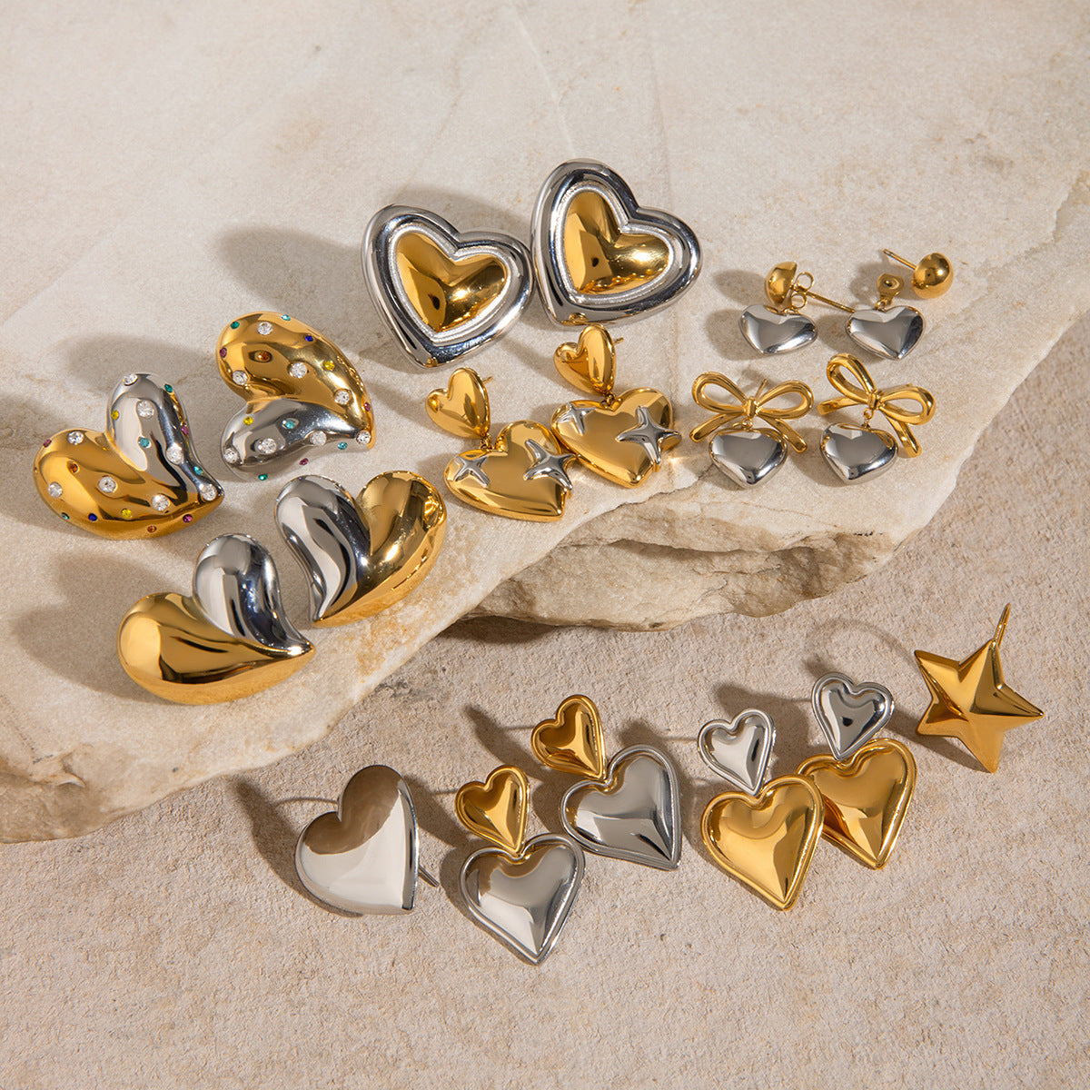 Two-tone heart earrings with bow and stacked-heart options in a group display