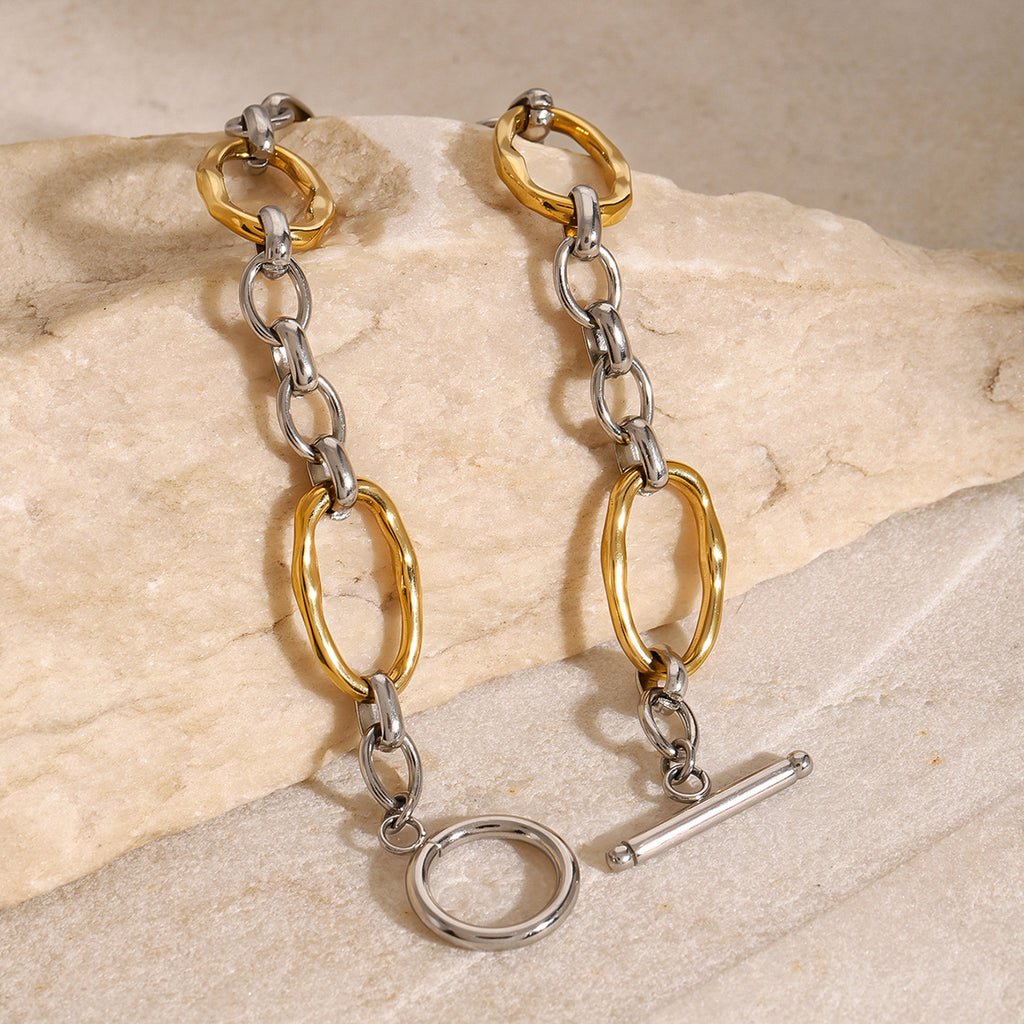 Gold and silver-tone link bracelet angled close-up