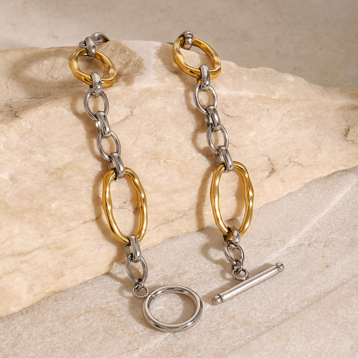 Gold and silver-tone link bracelet angled close-up