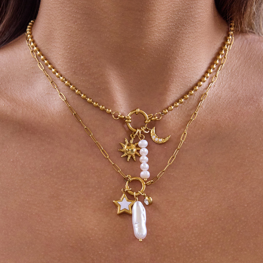 Gold-tone stainless steel pearl and charm necklaces worn layered