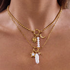 Gold-tone stainless steel pearl and charm necklaces worn layered