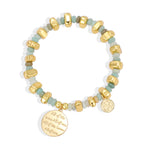 isolated pale aqua bead bracelet with two medallion charms