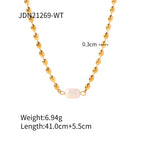 White bead accent necklace on gold-tone chain