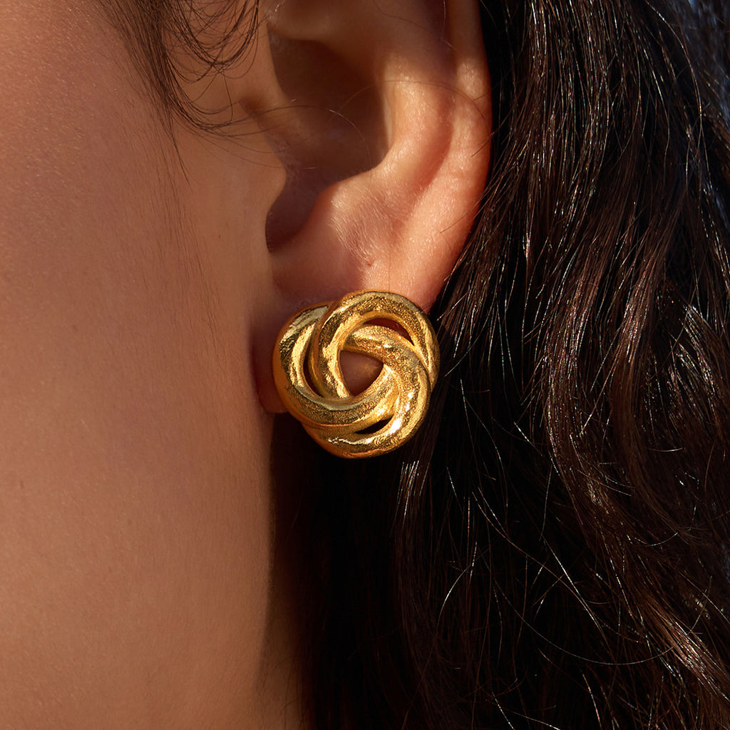 Interlocking knot stud shown on the ear