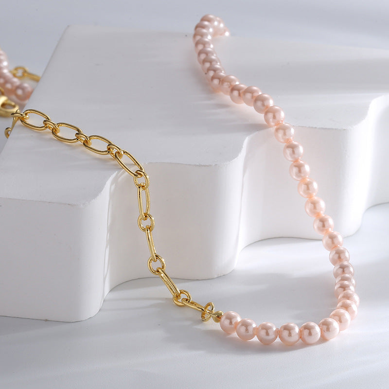 pink shell bead and gold plated oval-link necklace on a white display