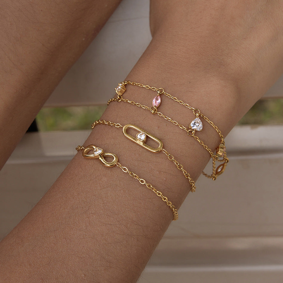 Pink and clear stone bracelet stacked with fine chains