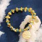 pale aqua and gold bead bracelet styled on navy fabric