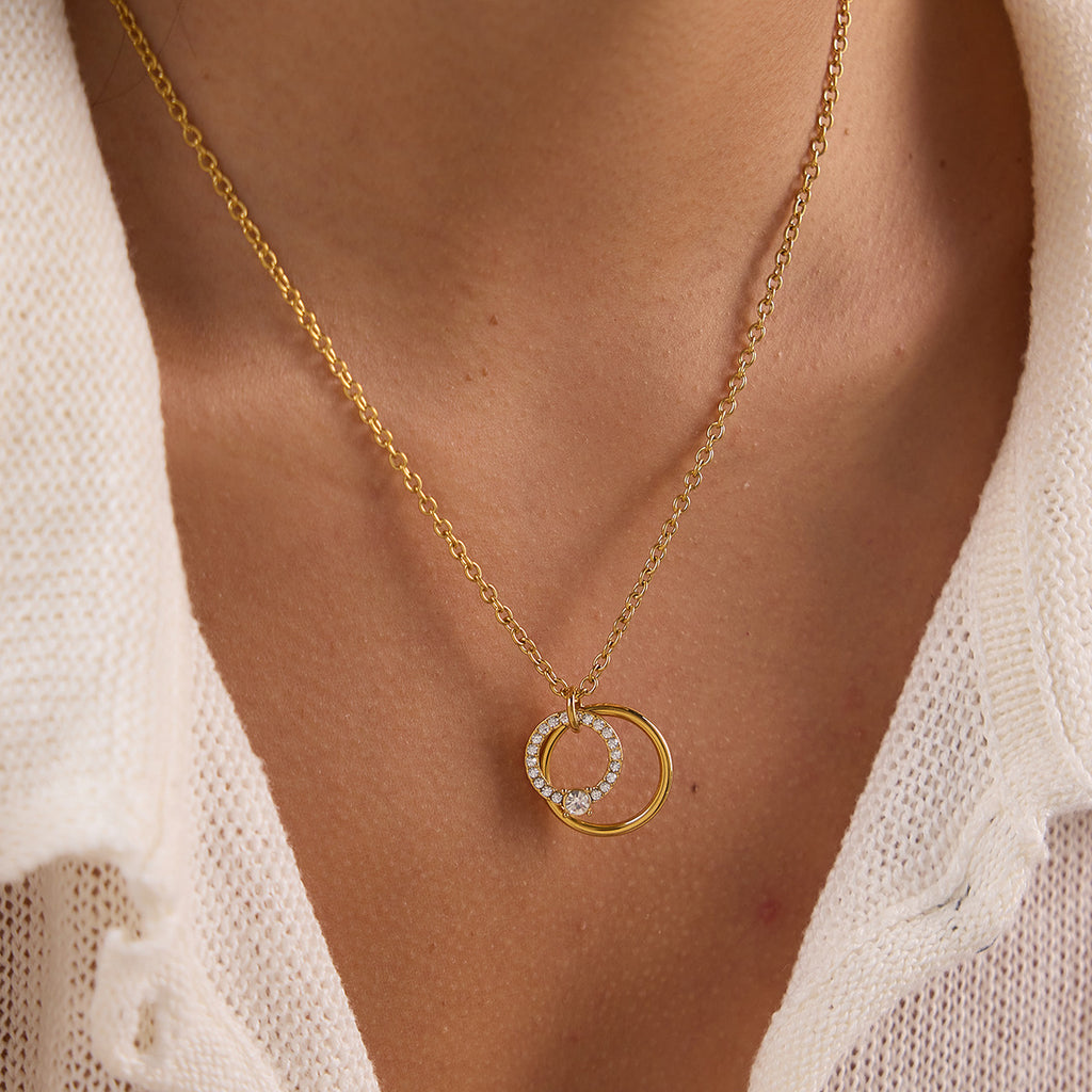 Close-up of overlapping circle pendant at neckline