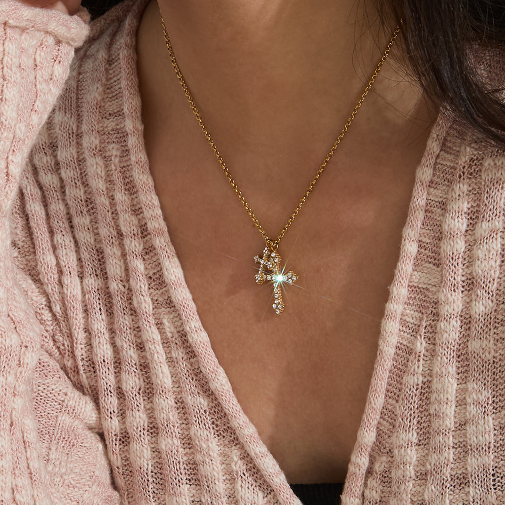 Small cross pendant necklace worn on the neck