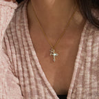 Small cross pendant necklace worn on the neck