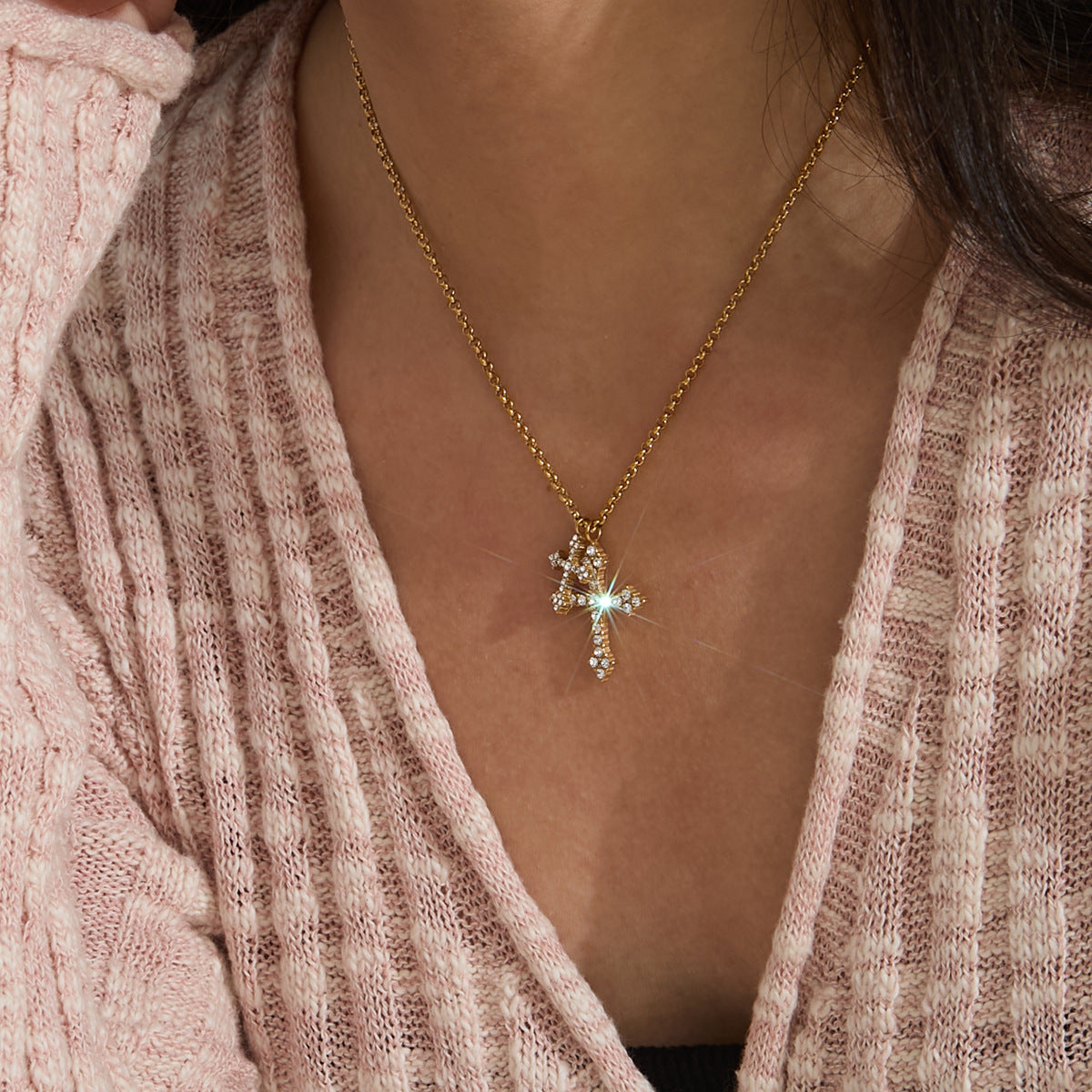 Small cross pendant necklace worn on the neck
