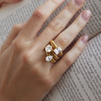 Square round and pear zirconia rings stacked on one finger